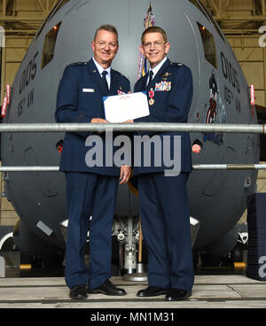 Col. Howard Wagner, the former commander of the 105th Airlift Wing, is presented the Legion of Merit during a change of command ceremony at Stewart Air National Guard Base, Newburgh, New York Aug. 6, 2017. The medal is awarded to those who distinguished themselves by exceptionally meritorious conduct in the performance of outstanding service. (U.S. Air Force photo by Senior Airman Terrence Clyburn) Stock Photo