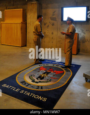 170808-N-SL853-005 GREAT LAKES, Il. (August 08, 2017) Rear Admiral Kyle Cozad, commander, Naval Education and Training Command, receives a Battle Stations 21 brief from Chief Warrant Officer Trevor Davis Aug. 8, at Recruit Training Command. The USS Trayer (BST-21), is a multimillion dollar capstone training facility that uses Hollywood-style special effects to create challenging and realistic training scenarios for recruits. Recruit divisions work through a 12-hour BST-21 experience as a comprehensive test of the skills and teamwork learned during their eight weeks of basic training at RTC. Im Stock Photo