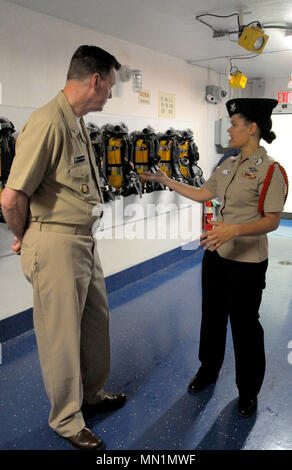 170808-N-SL853-044 GREAT LAKES, Il. (August 08, 2017) Rear Admiral Kyle Cozad, commander, Naval Education and Training Command, receives a Battle Stations 21 brief from Hospital Corpsman First Class, Fleet Marine Forces, Shannon Dawkins Aug. 8, at Recruit Training Command. The USS Trayer (BST-21), is a multimillion dollar capstone training facility that uses Hollywood-style special effects to create challenging and realistic training scenarios for recruits. Recruit divisions work through a 12-hour BST-21 experience as a comprehensive test of the skills and teamwork learned during their eight w Stock Photo