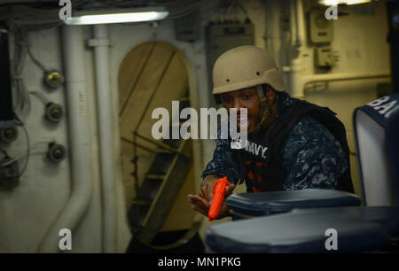 MAYPORT, Fla. (August 8, 2017) Master-at-Arms 1st Class Deandre Forbes moves through the mess deck of the amphibious assault ship USS Iwo Jima (LHD 7) during an anti-terrorism force protection drill. Iwo Jima is in port conducting a scheduled continuous maintenance availability in preparation for their upcoming deployment. (U.S. Navy photo by Mass Communication Specialist Seaman Dary M. Patten/Released) Stock Photo