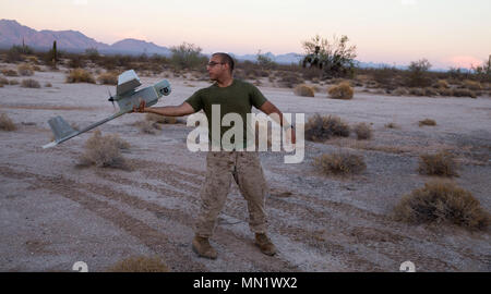 RQ-11 Raven is a small unmanned aerial vehicle used by the United States Marine Corps for reconnaissance and surveillance missions. The archival image documents a Marine from 2nd Battalion, 4th Marines launching the system during Exercise Summer Fury at Yuma, Arizona, on August 5, 2017, as part of night air and urban assault training. Stock Photo