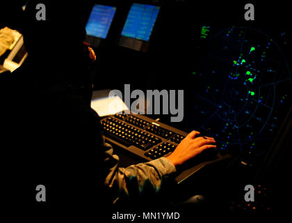 U.S. Air Force Tech. Sgt. Nichole Headley, 8th Operations Support Squadron Airfield Automation Management NCO in-charge, views a display screen showing aircraft in the surrounding airspace at Kunsan Air Base, Republic of Korea, Aug. 2, 2017. Headley, who works in the Radar Approach Control section, is responsible for directing aircraft at larger distances that cannot be visually seen. (U.S. Air Force photo by Staff Sgt. Victoria H. Taylor) Stock Photo