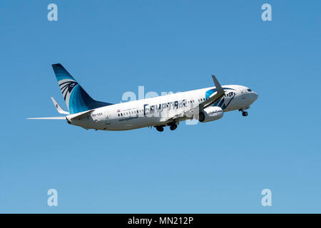 Boeing 737-800, two engine short- to medium-range, narrow-body jet airliner from EgyptAir, Egyptian airline in flight against blue sky Stock Photo
