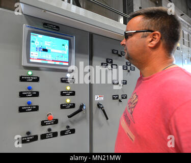 Wright-Patterson Air Force Base is a United States Air Force installation in Ohio that supports the 88th Air Base Wing. The archival image records a boiler plant mechanic inspecting a control panel at the base power plant on Aug. 8, 2017; the panel regulates ignition and flame control for boilers producing steam and heat for base buildings. Stock Photo