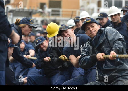 Crewmembers of the Coast Guard Cutter Sycamore, homeported in Cordova, Alaska, use every ounce of strength to beat the Coast Guard Cutter Hickory, taking first place in the tug-o-war during the Buoy Tender Roundup Olympics at Coast Guard Station Juneau, Alaska, Aug. 16, 2017. The Olympics is a competition that not only builds morale amongst cutter members but also provides a fun alternative to every day training in events such as the chain pull, survival swim and the heat-and-beat. U.S. Coast Guard photo by Petty Officer 1st Class Jon-Paul Rios. Stock Photo