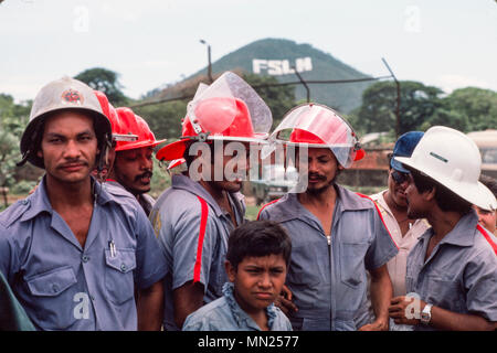 Managua, Nicaragua, June 1986; Factory workers doing fire-fighting training with the city's fire brigade. Stock Photo