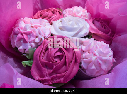 Beautiful pink ice cupcakes that look like a bouquet of roses and flowers Stock Photo