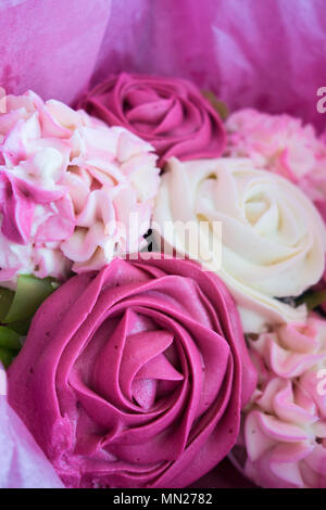 Beautiful pink ice cupcakes that look like a bouquet of roses and flowers Stock Photo