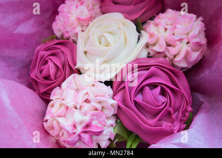 Beautiful pink ice cupcakes that look like a bouquet of roses and flowers Stock Photo