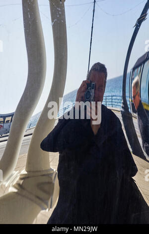 Distorted photographer in a plastic mirror Stock Photo