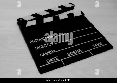 Production film slate black and white on wooden background Stock Photo