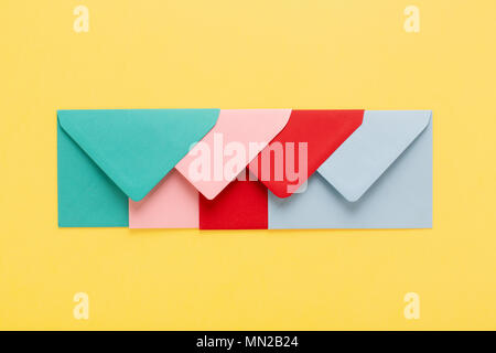 Abstract background with colofful envelopes on yellow background. Minimal styled, postal concept. Stock Photo