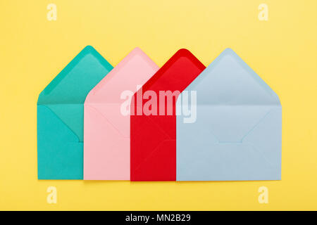 Abstract background with colorful envelopes on yellow paper. Conceptual card with association. Stock Photo