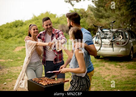 Group of young people enjoying barbecue party in the nature Stock Photo