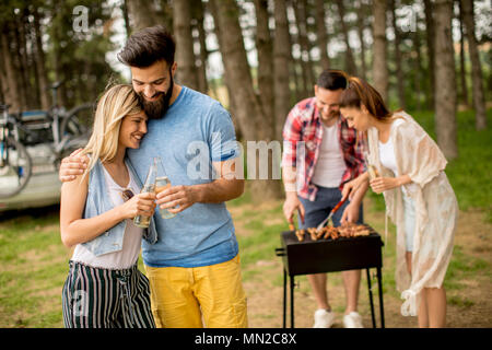 Group of young people enjoying barbecue party in the nature Stock Photo