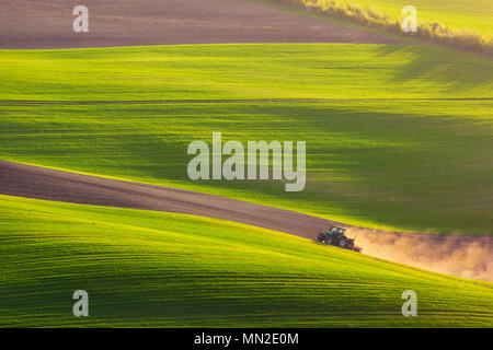 tractor plows the field in the spring Stock Photo