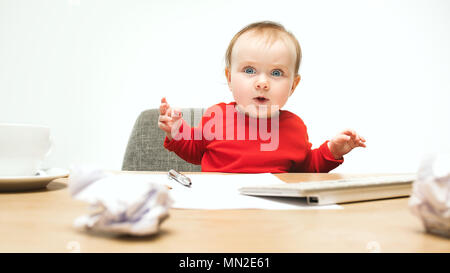 Happy child baby girl toddler sitting with keyboard of computer isolated on a white background Stock Photo