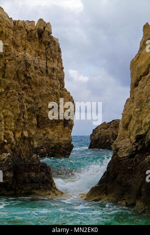 Waves hitting limestone rocks on the shore of the Greek island Cephalonia Stock Photo