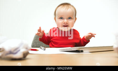 Happy child baby girl toddler sitting with keyboard of computer isolated on a white background Stock Photo