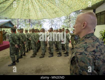 U.S. Marine Corps Brig. Gen. Thomas Weidley, commanding general, 1st Marine Aircraft Wing, stands at parade rest with members of the Armed Forces of the Philippines during Exercise Balikatan at Naval Base Camilo Osias, Santa Ana, Cagayan, Philippines May 10, 2018, May 10, 2018. Exercise Balikatan, in its 34th iteration, is an annual U.S.-Philippine military training exercise focused on a variety of missions, including humanitarian assistance and disaster relief, counterterrorism, and other combined military operations held from May 7 to May 18. (U.S. Navy photo by Mass Communication Specialist Stock Photo