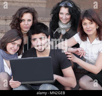 group of friends of students with a laptop Stock Photo