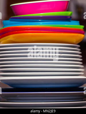 Stack of  rainbow dishes with ceramic white dish wear. Stock Image. Stock Photo