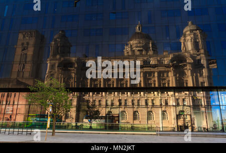 The Port of Liverpool Building reflected in the windows of Mann Island, Liverpool Stock Photo