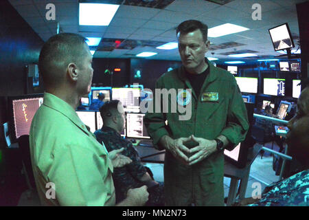 PENSACOLA, Fla. -- Commander, Naval Education and Training Command (NETC) Rear Admiral Kyle Cozad (right) receives a brief on Naval Air Technical Training Center (NATTC) Air Traffic Control courses Aug. 18 during Cozad's familiarization tour of Center for Naval Aviation Technical Training (CNATT) commands aboard Naval Air Station Pensacola, Florida. Stock Photo