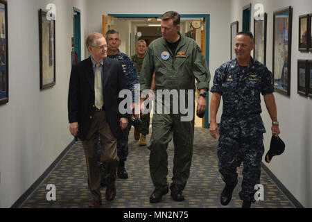 PENSACOLA, Fla. -- Commander, Naval Education and Training Command (NETC) Rear Admiral Kyle Cozad (center) is greeted by Center for Naval Aviaition Technical Training (CNATT) Commanding Officer Capt. Eric Simon (right) and CNATT Executive Director Mr. Charles Kicker Aug. 18 during Cozad's familiarization tour of CNATT commands aboard Naval Air Station Pensacola, Florida. Stock Photo