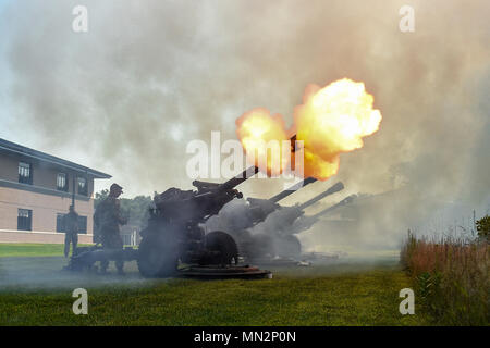 A howitzer cannon fires off a blank round during a 21-gun salute in honor of the 88th Regional Support Command’s centennial anniversary at Fort McCoy, Wisconsin on Aug. 19, 2017. The cannons were provided and fired by the 2nd Battalion, 122 Field Artillery Regiment from the Illinois National Guard.   (U.S. Army photo by Sgt. Aaron Berogan) Stock Photo