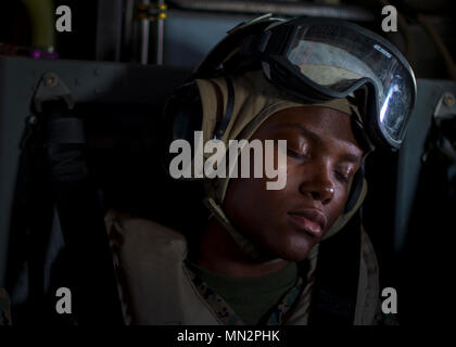 A U.S. Marine Corps member takes a moment to rest during a MV-22 Osprey flight over Hokkaido, Japan, Aug. 18, 2017. This specific Osprey departed from Misawa Air Base, Japan, and landed on Hokkaido for a historical Northern Viper 17 media day event with Japan Ground Self Defense Force Col. Seiichi Iwana, deputy commander of Japan Ground Self-Defense Force 11th Brigade, and Col. James F. Harp, the commanding officer of Marine Aircraft Group 36, 1st Marine Aircraft Wing. Misawa AB has been a hub for U.S. Marine personnel and aircraft, exercising Team Misawa’s ability to thrive with an influx of  Stock Photo