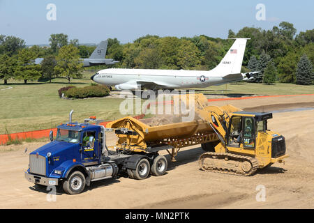 Construction workers operate heavy equipment while removing debris near the intersection of Nelson Dr. and SAC Blvd. August 17 on Offutt Air Force Base, Nebraska. They are constructing a road that will provide additional access to a new dormitory being built next to Tuskegee Hall. The dormitory is scheduled for completion in February 2019. (U.S. Air Force photo by Delanie Stafford) Stock Photo