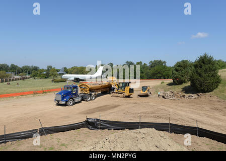 Construction workers operate heavy equipment while removing debris near the intersection of Nelson Dr. and SAC Blvd. August 17 on Offutt Air Force Base, Nebraska. They are constructing a road that will provide additional access to a new dormitory being built next to Tuskegee Hall. The dormitory is scheduled for completion in February 2019. (U.S. Air Force photo by Delanie Stafford) Stock Photo