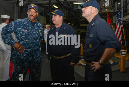 MAYPORT, Fla. (August 22, 2017) Rear Adm. Jesse A. Wilson, Jr., commander, Naval Surface Force Atlantic, speaks with Capt. James R. Midkiff, commanding officer of the amphibious assault ship USS Iwo Jims (LHD 7) and Command Master Chief William J. Mullinax on the quarterdeck of the Iwo Jima. Iwo Jima is in port conducting a scheduled continuous maintenance availability in preparation for their upcoming deployment. (U.S. Navy photo by Mass Communication Specialist 3rd Class Kevin Leitner/Released) Stock Photo