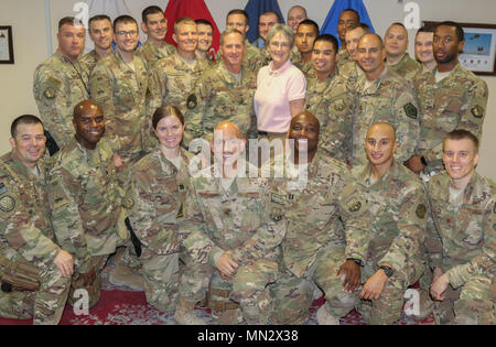 (Center left) Brig. Gen. Andrew A. Croft, deputy commanding general – air for Combined Forces Land Component Command – Operation Inherent Resolve, Gen. David L. Goldfein, Chief of Staff of the U.S. Air Force, and Dr. Heather Wilson, Secretary of the U.S. Air Force, pose for a group photo with Airmen in Baghdad, Iraq, Aug. 19, 2017. The visit was part of a battlefield circulation in Iraq to visit Airmen and observe the impact of Air Force contributions at CJFLCC-OIR. (US Army Photo by Sgt. Von Marie Donato) Stock Photo