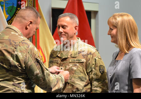 U.S. Army Reserve Deputy Commanding General Scottie Carpenter pins Major General Steven Ainsworth with his wife Mrs. Susan Ainsworth by his side at Naval Air Station Joint Reserve Base New Orleans, August 25, 2017. The event preceded an assumption of command ceremony in which he became the new commanding general of the 377th Theater Sustainment Command.  (U.S. Army Reserve by Sgt. Jameson Crabtree) Stock Photo