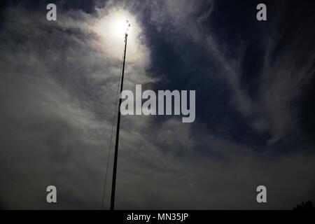 Fort McCoy is a United States Army installation located in Wisconsin. The garrison flag pole is silhouetted at approximately 1:11 p.m. on Aug. 21, 2017, during a partial solar eclipse visible in the state, while totality occurred further south in the United States. The archival image documents the eclipse as observed on the installation. Stock Photo