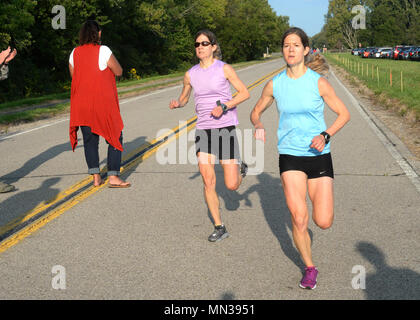 From the left twins Tara and Kara Storage both with the Air Force Research Laboratory Materiel and Manufacturing directorate cross the finish line first to win the annual Suicide Awareness and Prevent...