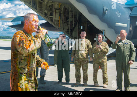 Members of the 347th Rescue Group congratulate Chief Master Sgt. Brandon Broughman, 347th RQG superintendent, as he celebrates completing his final flight, Aug. 17, 2017, at Moody Air Force Base, Ga. Broughman concluded his 30-year career as a loadmaster on Sept. 1. During his tenure, he dedicated service to more than 5 variants of C-130’s in air mobility and tactical airlift support. (U.S. Air Force photo by Senior Airman Greg Nash) Stock Photo