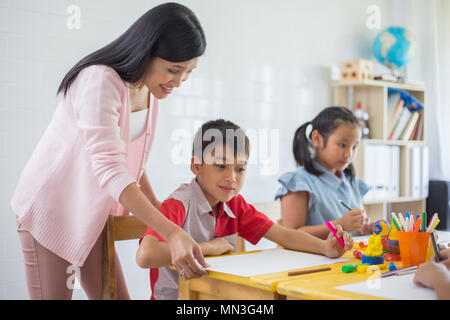 Asian students and woman teacher teach and learning art & painting at class room in school Stock Photo
