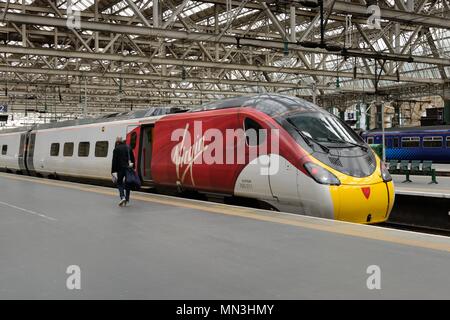 A Virgin train sitting at the platform in Glasgow's Central Station, Scotland, UK Stock Photo