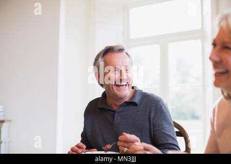 Laughing mature couple eating Stock Photo