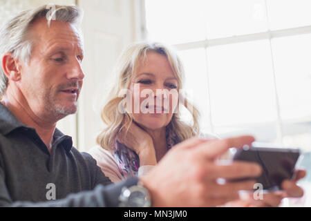 Mature couple using smart phone Stock Photo