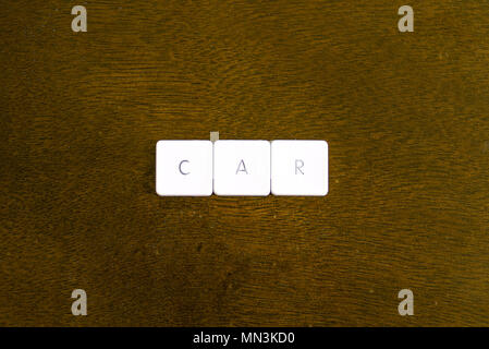 CAR word written on plastic keyboard alphabet with dark background Stock Photo