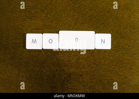 MOON word written on plastic keyboard alphabet with dark background Stock Photo