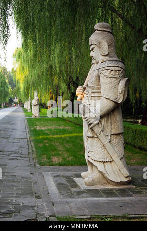 Ornate stone-carved Chinese warrior statues in a park near the Ming Tombs, northwest of Beijing, China. Stock Photo