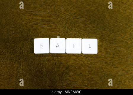FAIL word written on plastic keyboard alphabet with dark background Stock Photo