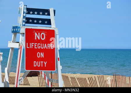 An empty lifeguard chair painted with an American flag pattern at the Lighthouse Beach on Lake Michigan, Evanston IL. Stock Photo