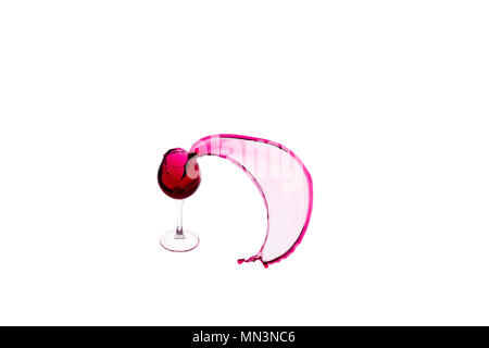 Falling wine glass with splashes of red wine on white isolated background Stock Photo