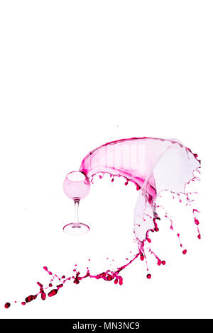 Falling wine glass with splashes of red wine on white isolated background Stock Photo